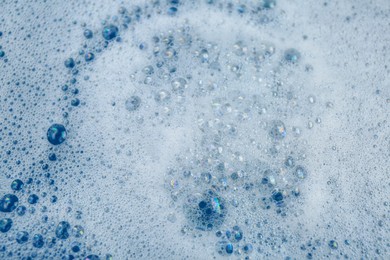 Photo of Detergent foam as background, top view. Hand washing laundry