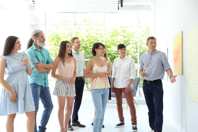 Photo of Group of people with guide at exhibition in art gallery