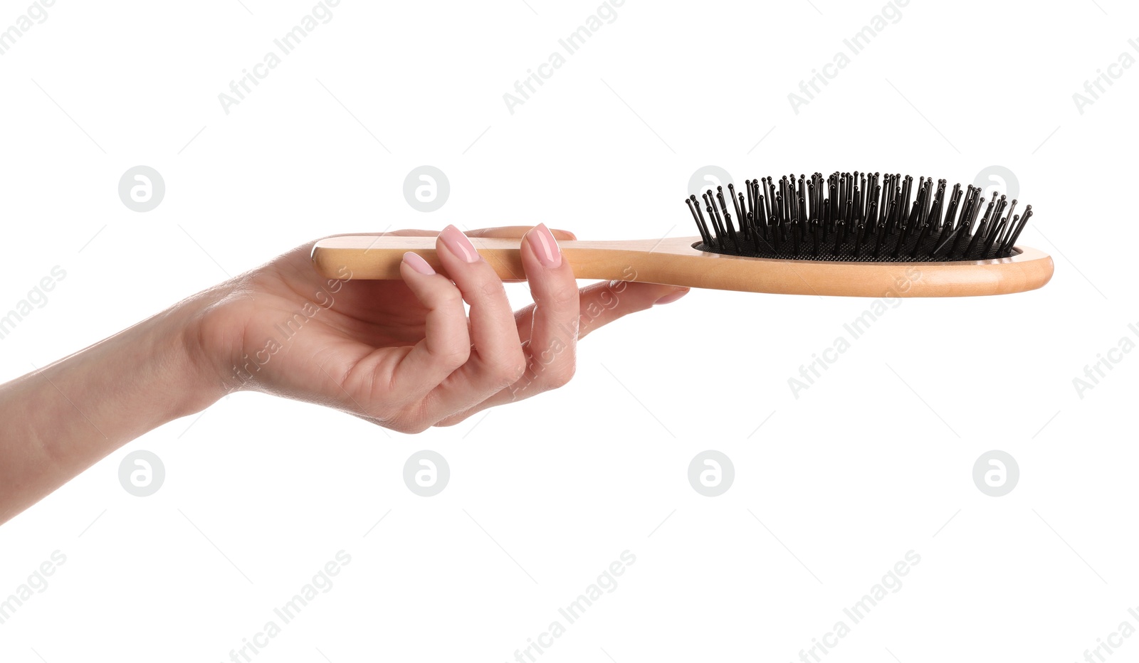 Photo of Woman holding wooden hair brush against white background, closeup