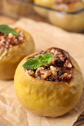 Baked apple with mint on parchment, closeup