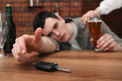 Woman stopping man from drunk driving, closeup. Don't drink and drive concept