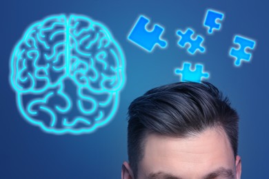 Image of Memory. Man, puzzle pieces and neon brain on blue background