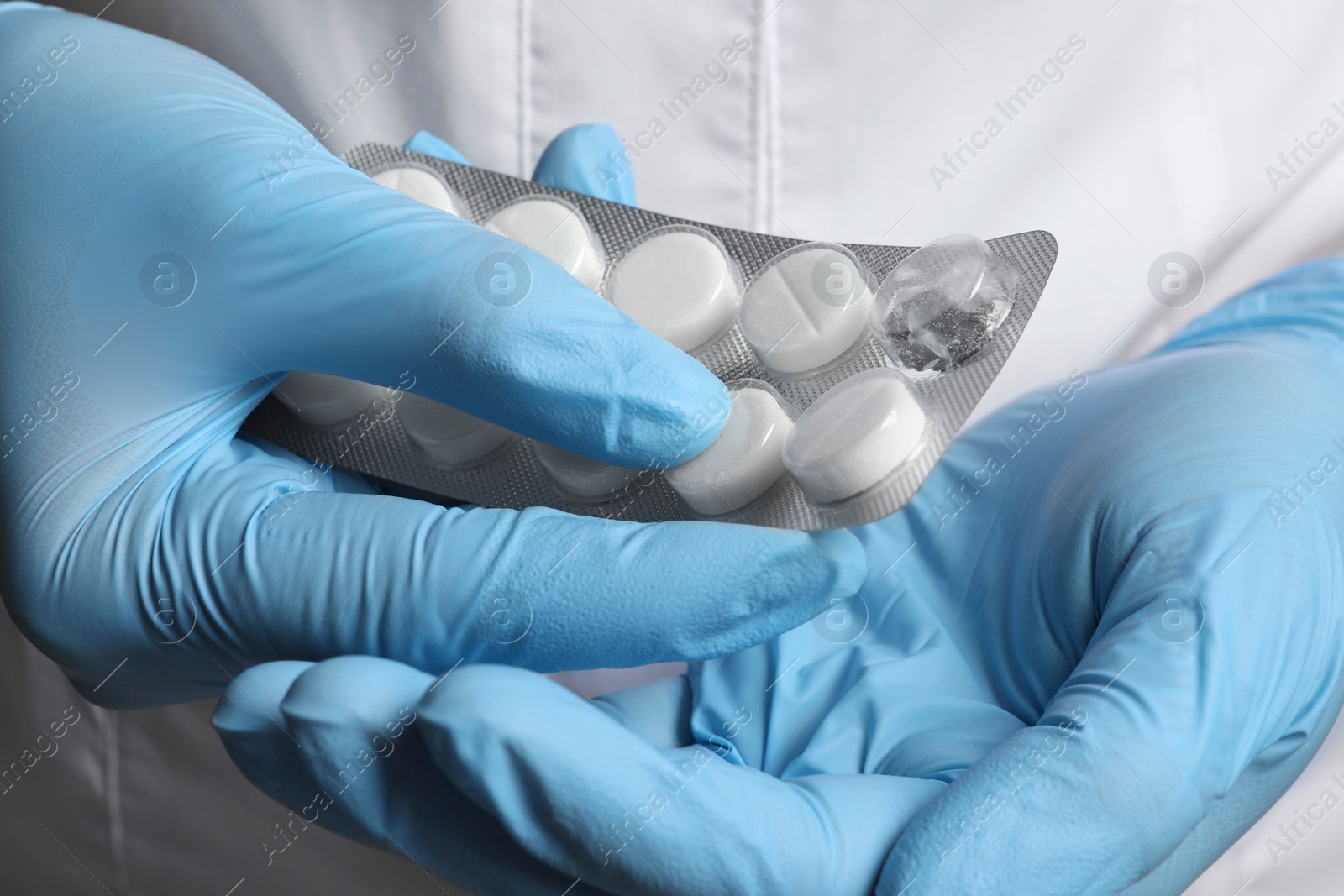 Photo of Doctor taking pill out from blister pack, closeup