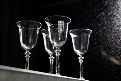 Photo of Empty clean glass on dark background, low angle view