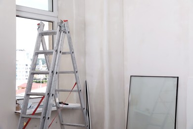 Double glazing window and folding ladder indoors