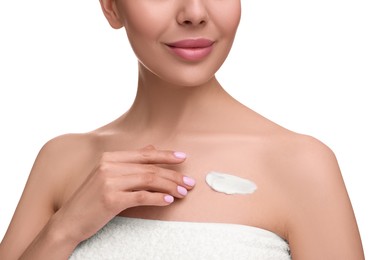 Woman with smear of body cream on her chest against white background, closeup