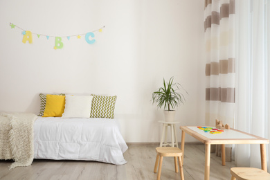 Photo of Modern child room interior with comfortable bed