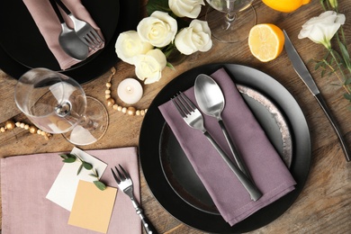 Elegant festive table setting on wooden background, flat lay