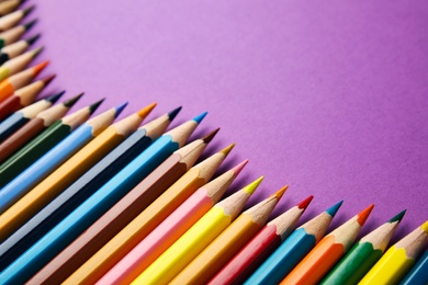 Photo of Composition with color pencils on purple background