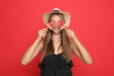 Photo of Beautiful girl with pieces of watermelon on red background