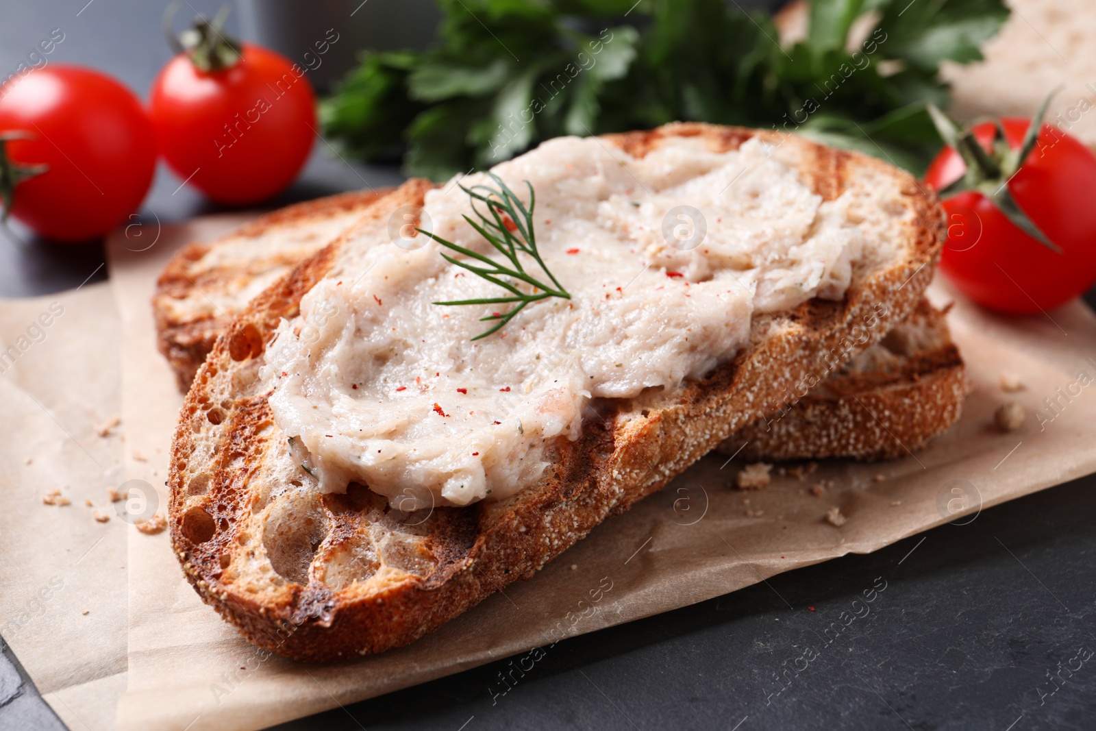 Photo of Toast with lard spread on black table, closeup