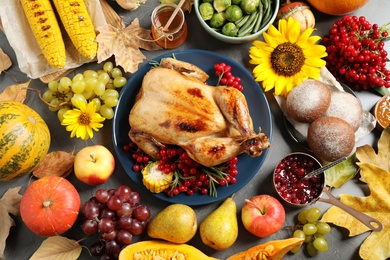 Photo of Flat lay composition with delicious turkey on grey background. Happy Thanksgiving day