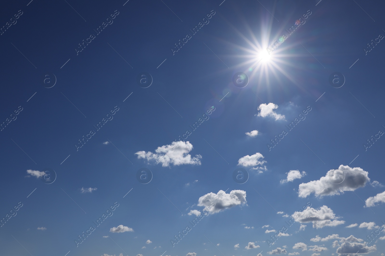 Photo of Beautiful white fluffy clouds and sun in blue sky