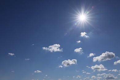 Photo of Beautiful white fluffy clouds and sun in blue sky