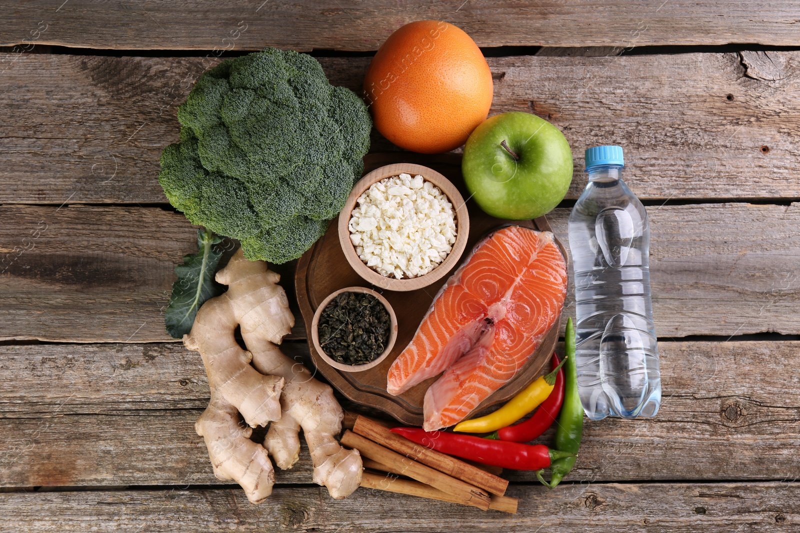 Photo of Metabolism. Different food products on wooden table, flat lay