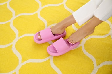 Photo of Woman in pink slippers indoors, closeup view