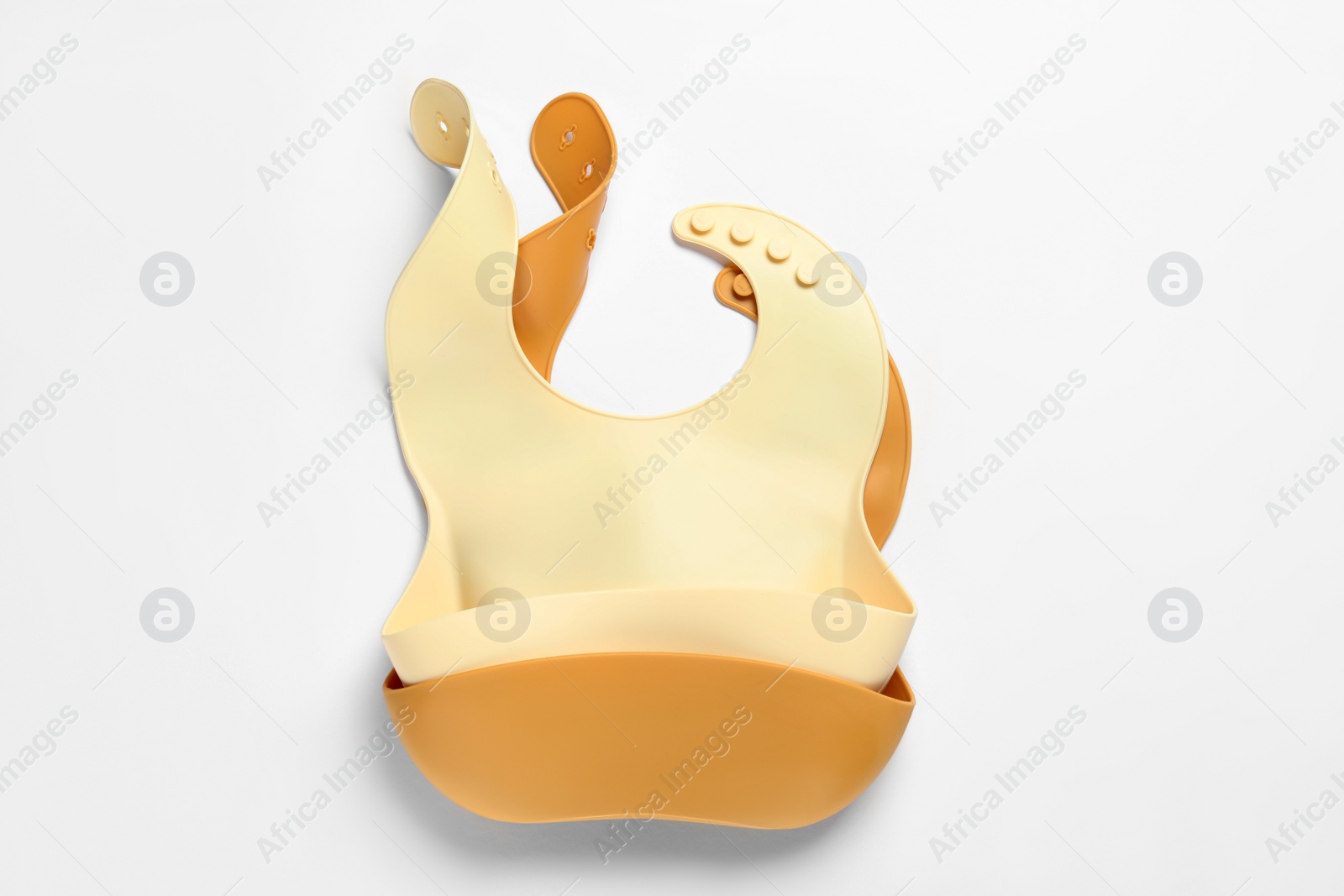 Photo of Color silicone baby bibs isolated on white, top view