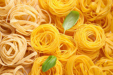 Photo of Different types of pasta as background, top view