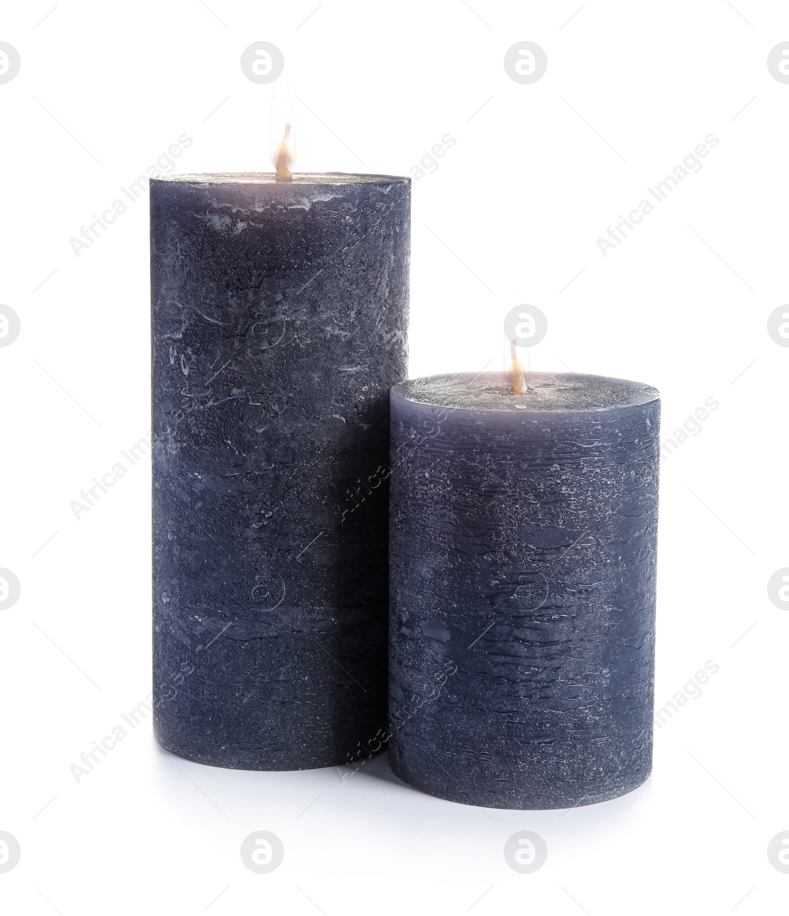 Photo of Two decorative wax candles on white background