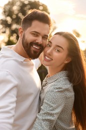 Lovely couple dancing together outdoors at sunset