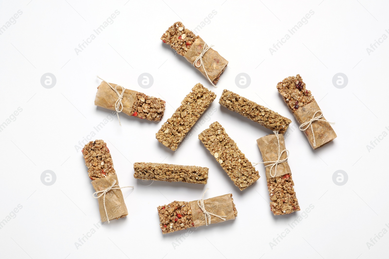 Photo of Tasty granola bars on white background, flat lay