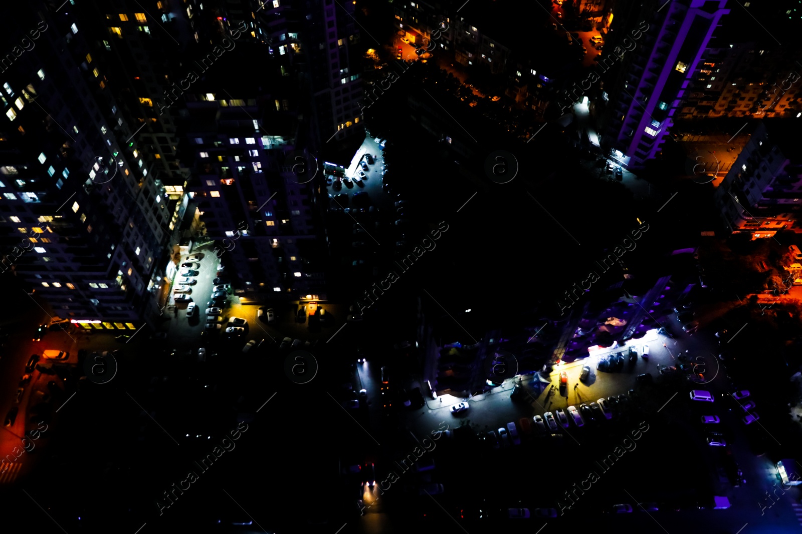 Photo of Picturesque view of city with buildings and cars at night