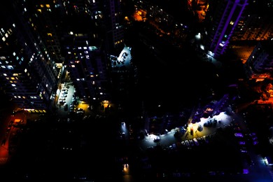 Photo of Picturesque view of city with buildings and cars at night