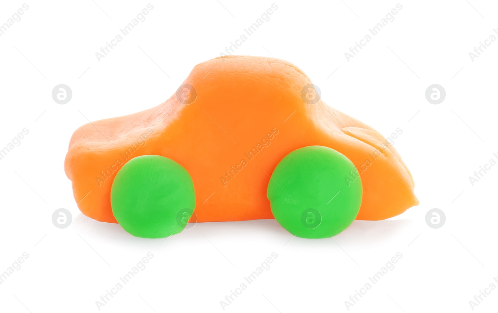 Photo of Small car made from play dough on white background