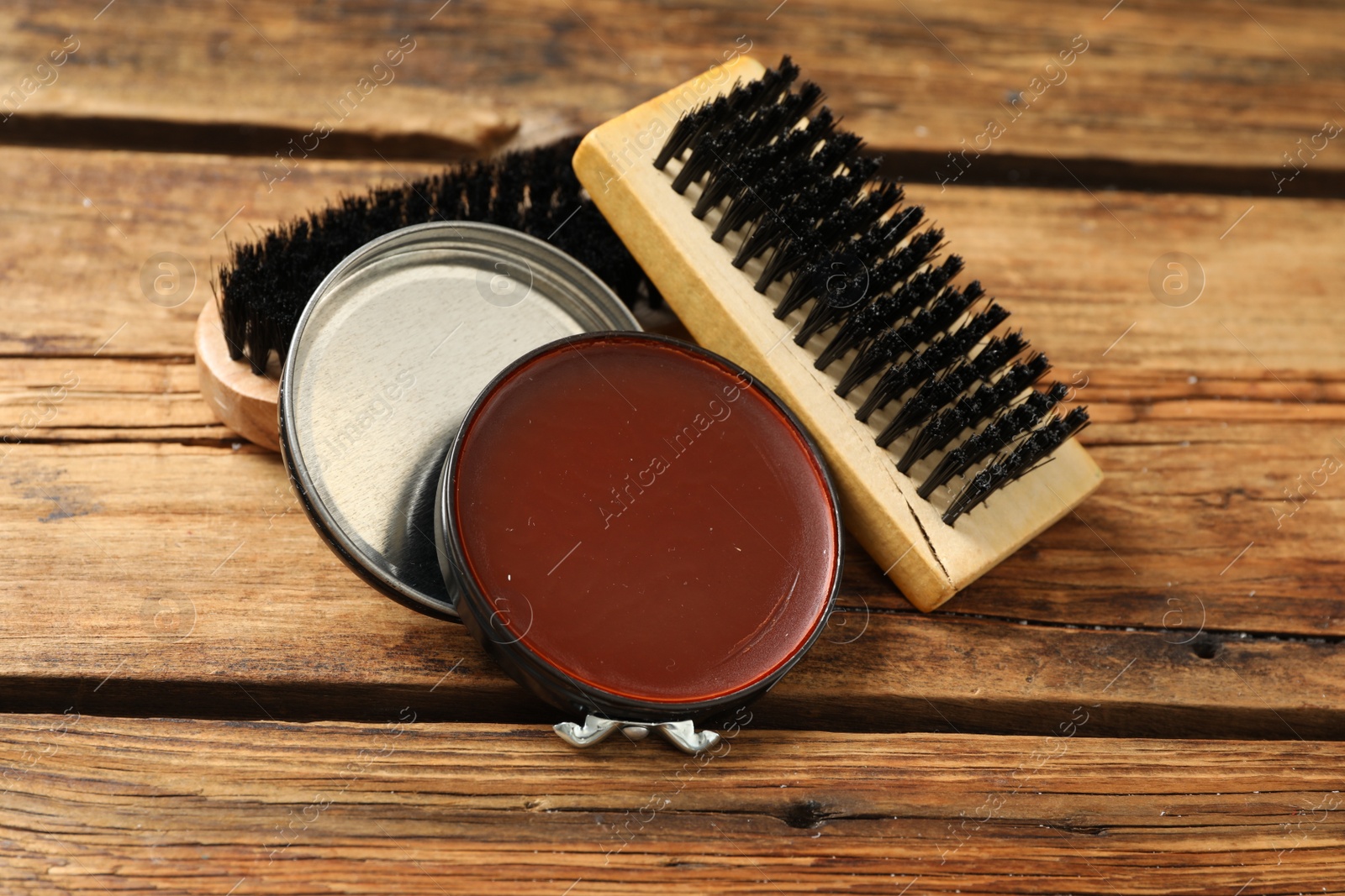 Photo of Shoe care accessories on wooden background, closeup