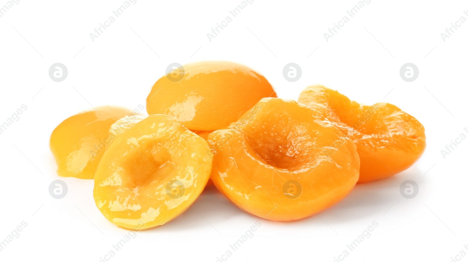 Photo of Halves of canned peaches on white background