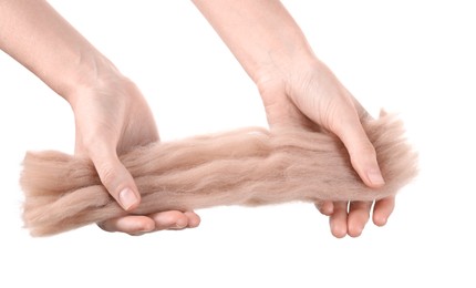 Photo of Woman holding beige felting wool on white background, closeup