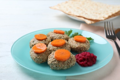 Photo of Plate of traditional Passover (Pesach) gefilte fish on wooden table