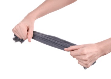 Woman holding grey felting wool on white background, closeup