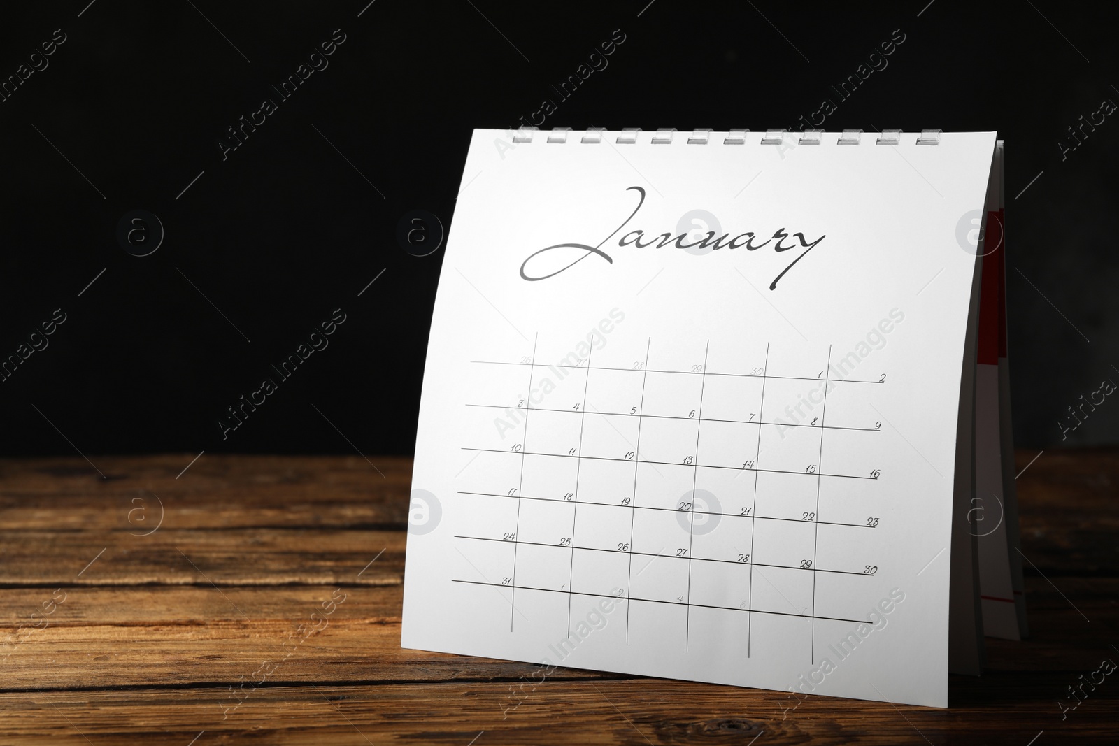 Photo of Paper calendar on wooden table, space for text. Planning concept