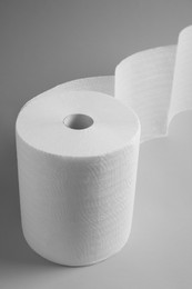 Photo of Roll of white paper towels on grey background