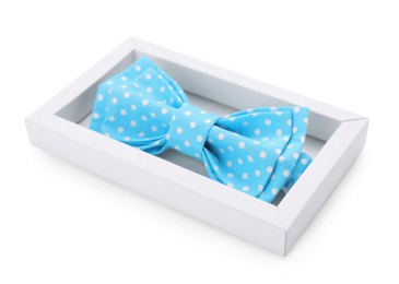 Photo of Stylish light blue bow tie with polka dot pattern in box on white background