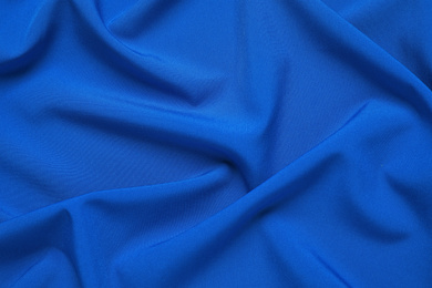 Photo of Crumpled fabric, top view. Color of the year 2020 (Classic blue)