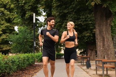 Healthy lifestyle. Happy couple running in park