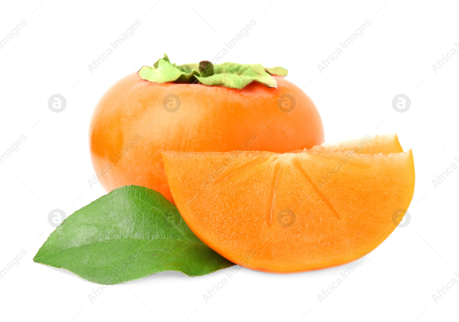 Photo of Whole and cut delicious ripe juicy persimmons with green leaf on white background