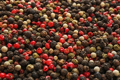 Photo of Different types of pepper as background. Natural spice
