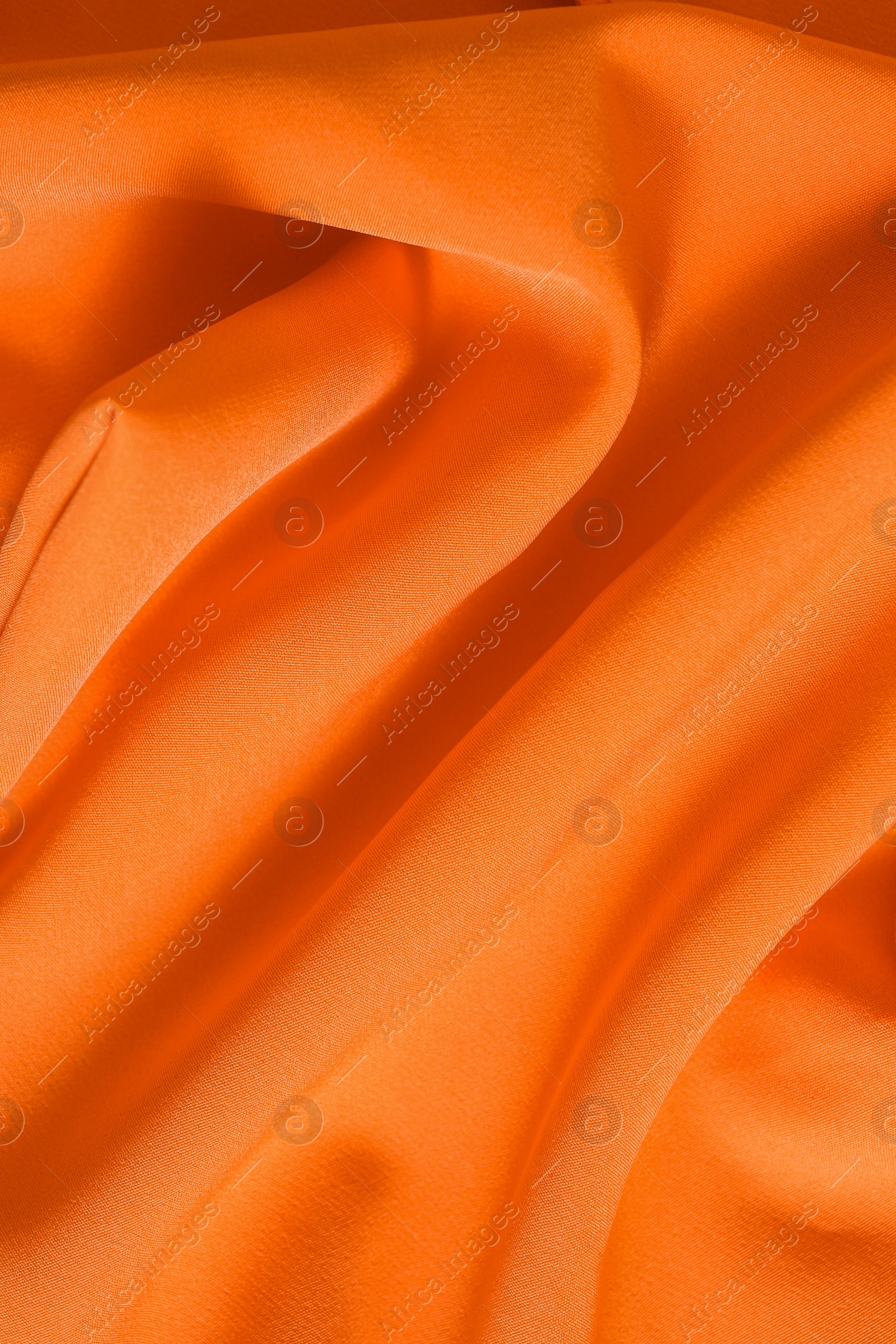 Photo of Texture of orange fabric as background, closeup