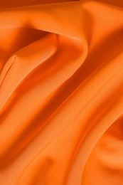 Texture of orange fabric as background, closeup