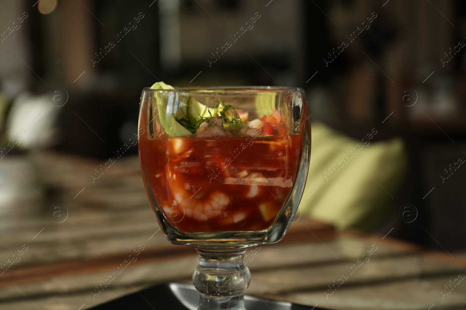 Photo of Delicious campechana cocktail with shrimps on table, closeup