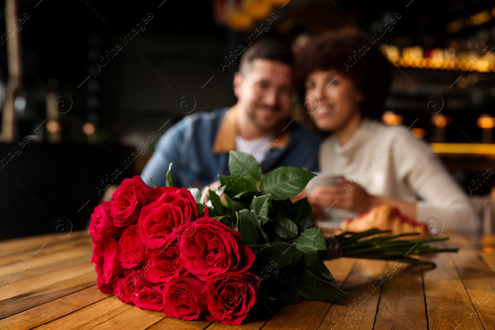 Photo of International dating. Happy couple spending time together in restaurant, selective focus