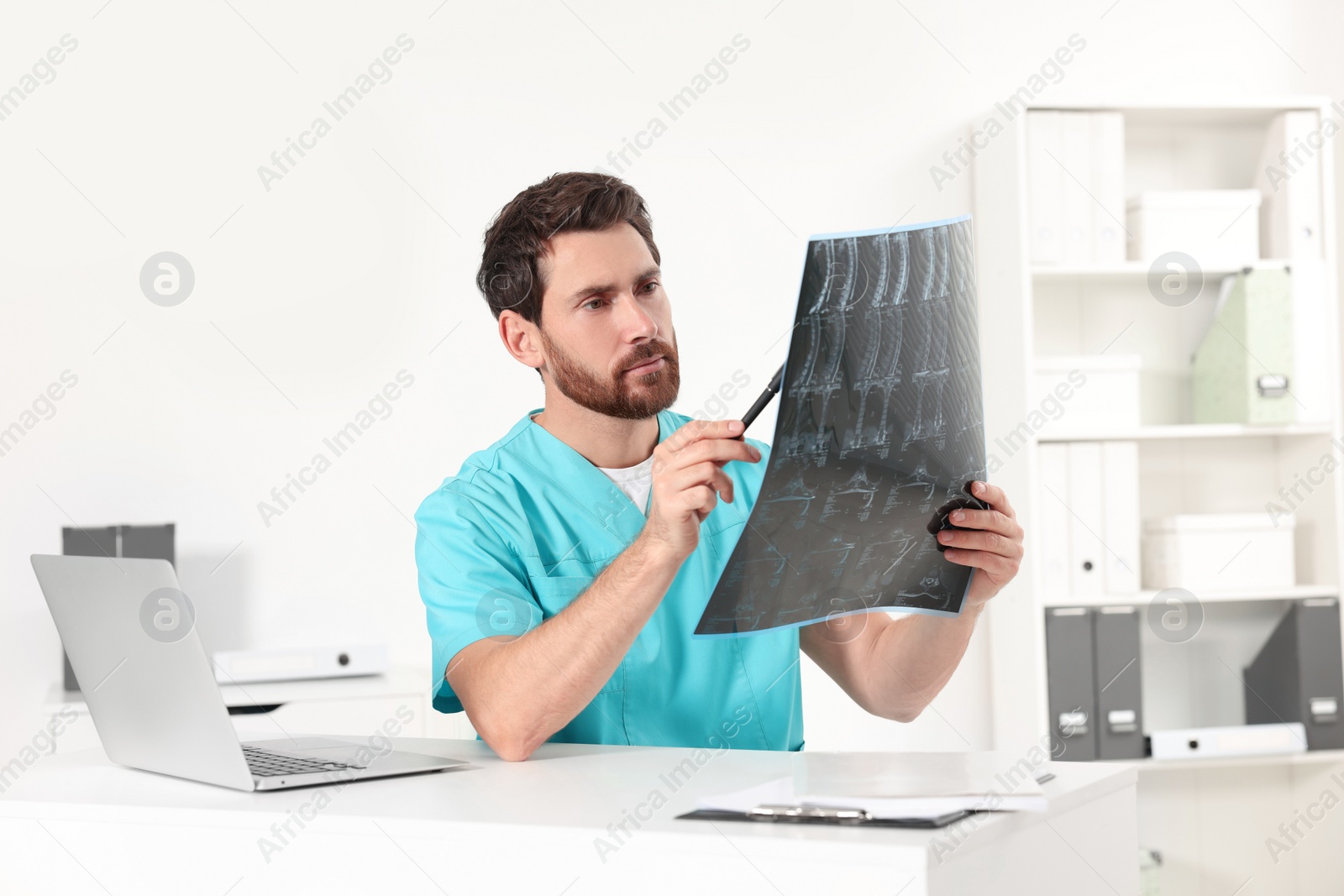 Photo of Doctor examining neck MRI scan in hospital