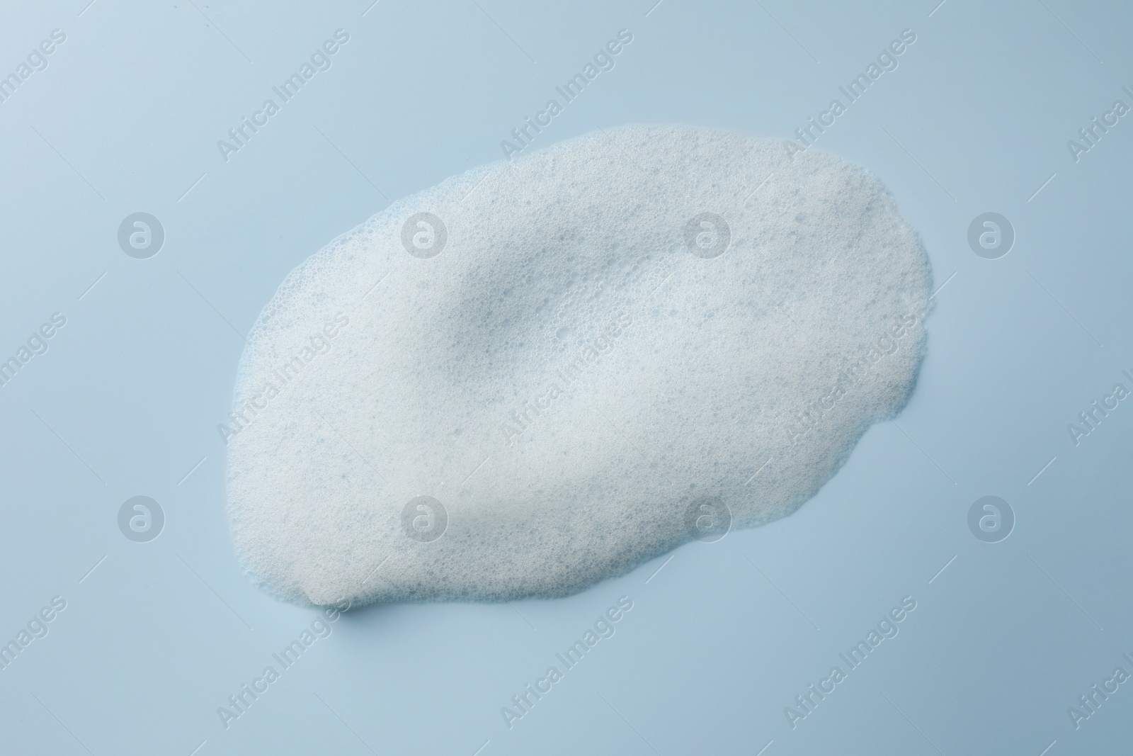 Photo of Foam sample on light blue background, top view