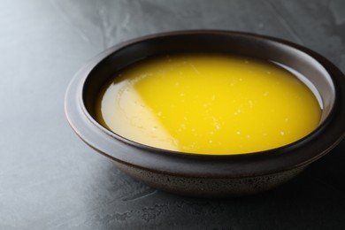 Clarified butter in bowl on black table