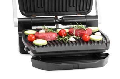 Electric grill with raw meat, rosemary and vegetables isolated on white