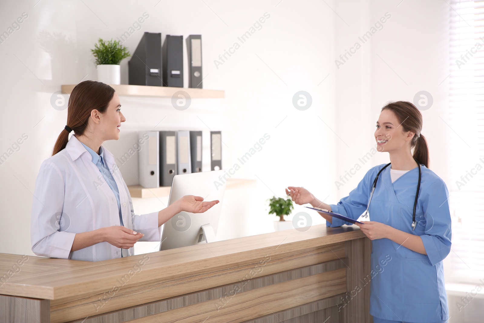 Photo of View of modern clinic with working doctors