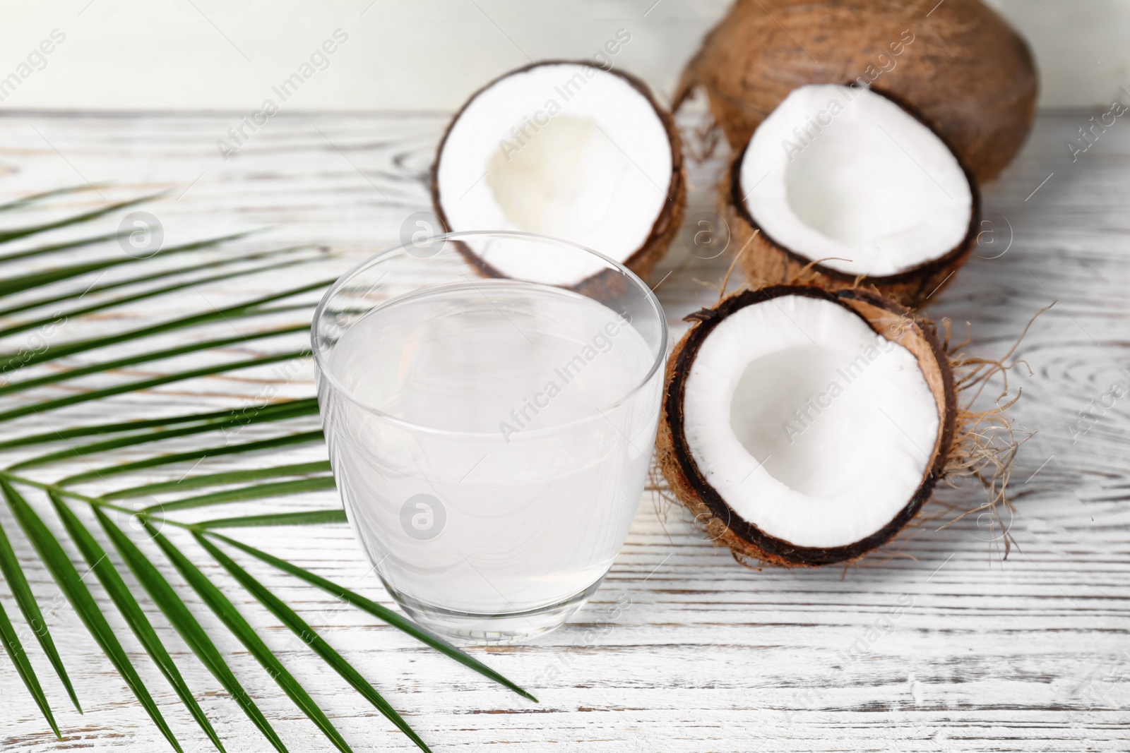 Photo of Glass of coconut water on wooden table
